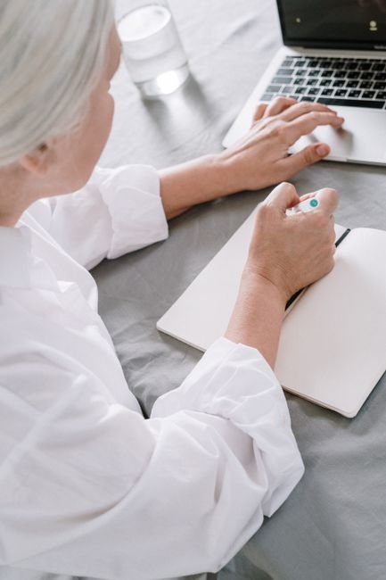 Grandmother writing a note to contact Grand Kids Fun