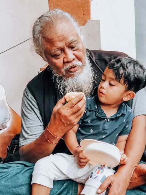 Grandfather and grandson eating out with grandkids together at lunch