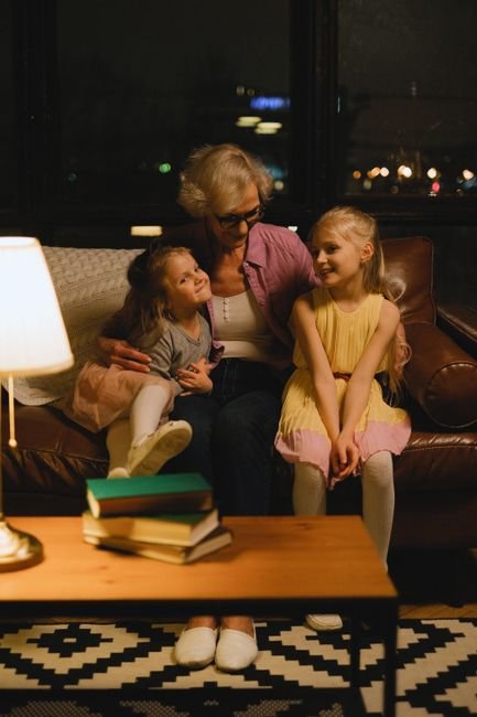 Grandmother bonding with her granddaughters in a cozy living room
