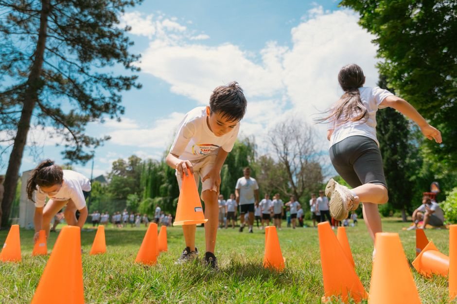 Children doing a physical development activity on an outdoor obstacle course